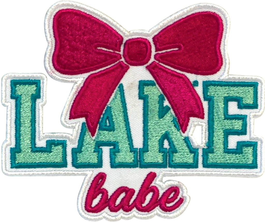 Embroidered patch with 'Lake babe' text and a pink bow on a white background