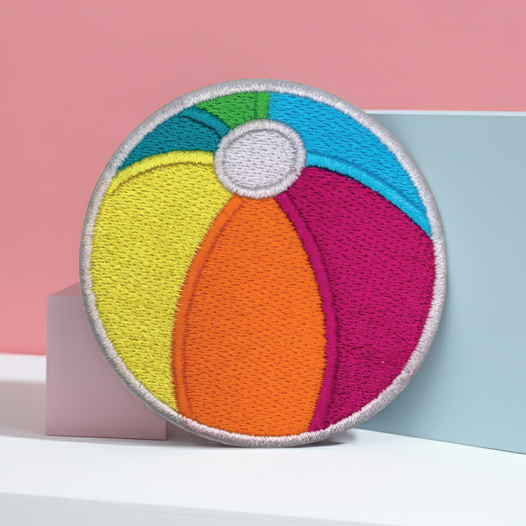Colorful beach ball patch on a pink and blue background